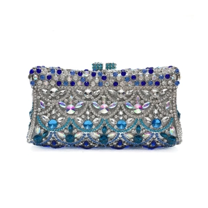 Detailed view of silver evening clutch with blue wave pattern and sparkling rhinestones