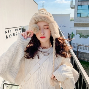 Chic beige knit trapper hat with faux fur trim and fluffy pom-poms for winter warmth