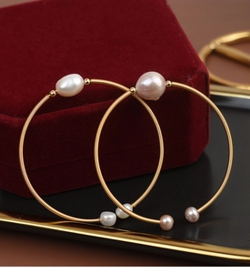Detail of handcrafted gold wire wrapped bangle with baroque freshwater pearls in velvet box