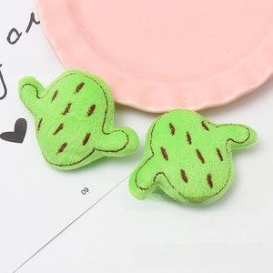 Detail of plush cactus DIY accessories with green embroidery and soft texture