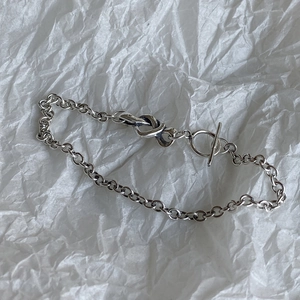 Macro view of 925 sterling silver chain bracelet with knot design and T-bar toggle clasp