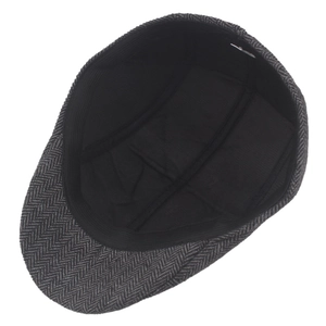Inside view of herringbone tweed ivy cap showing black lining and elastic sweatband