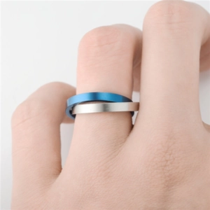 Blue and silver titanium steel spinning ring for stress relief shown on finger