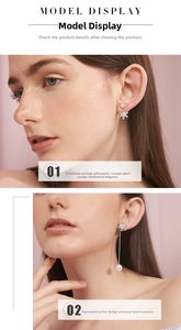Detail of asymmetric snowflake earrings with long chain fringe and round pearls