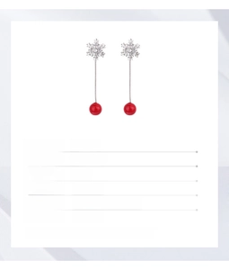Detail view of silver snowflake tassel earrings with red bead accents and dimensions