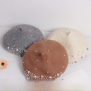 Detail of wool berets for girls featuring elegant pearl and rhinestone embellishments
