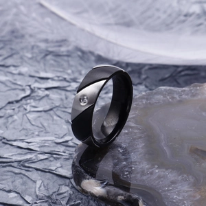 Two-tone matte black and brushed silver steel ring with diagonal facets and inlaid gemstone