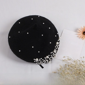 Close-up of black wool beret for girls featuring elegant pearl and rhinestone embellishments