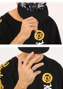 Close-up of minimalist two-tone steel rings with single stone on model's hand