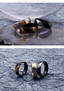 Detail of two-tone steel rings with brushed finish and inlaid cubic zirconia stones