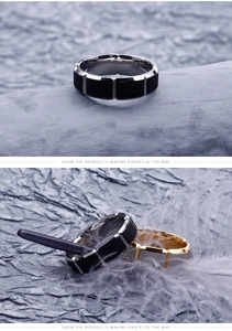 Detail of two-tone stainless steel rings with vertical grooves on textured paper