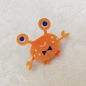 Plush squeaky dog toy featuring a cute orange crab shape with a blue bow decoration