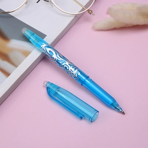 Blue transparent erasable gel pen with silver pattern decoration on pink background