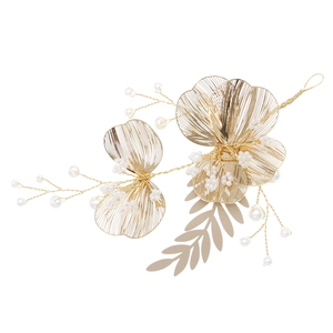 Detailed view of handmade gold wire floral bridal hairpiece with white pearls