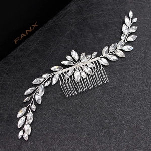 Silver bridal hair comb with marquise rhinestones and leaf pattern on black background