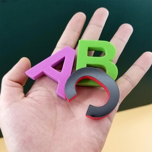 Magnetic foam alphabet letters A B C held in hand for educational children learning