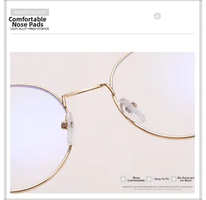 Detail of soft silicone nose pads on lightweight gold round metal eyeglass frames