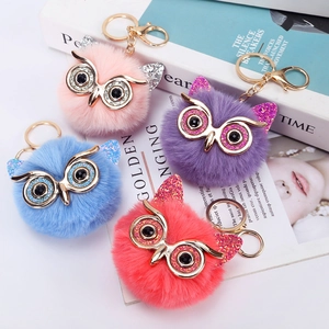 Glittery owl faux fur pompom keychain in pink, purple, blue and red with gold metal rings