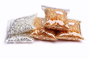 Bulk gold and silver jump rings in transparent bags for jewelry making DIY projects