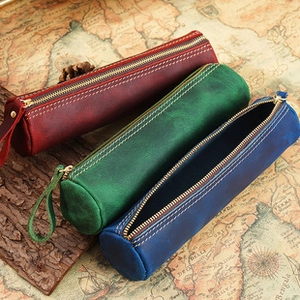 Vintage crazy horse leather measuring tapes in red, green, and blue on a world map