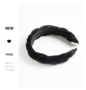 Detail of black velvet braided headband showing twisted texture and comfortable ribbon tips