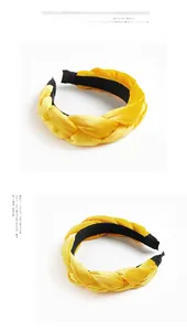 Detail of yellow velvet braided headband showing textured twist and black non-slip lining