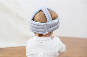 Detailed back view of a grey baby safety helmet with soft lining and star pattern
