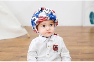 Close-up of baby wearing a star and stripe pattern safety helmet with a secure chin strap