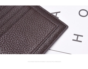Close-up of brown lychee grain leather wallet showing fine stitching and texture details