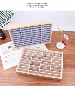 Detail shot of wooden jewelry tray with ice grey and beige velvet slots for bracelets