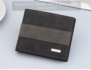 Detail of bifold wallet with grey leather texture and orange stitching accents