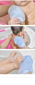 Macro view of light blue silicone baby bath brush with soft bristles and ergonomic ring grip