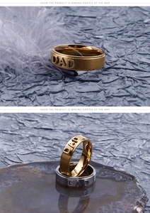 Detailed view of gold and silver DAD embossed stainless steel rings with brushed finish