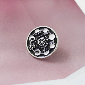 Cosmic planetary enamel pin featuring moon phases and celestial starry patterns