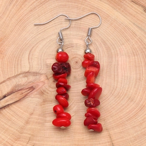 Bohemian dangle earrings with natural red stone beads and stainless steel hooks on wood