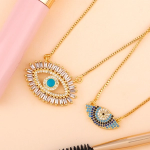 Golden Evil Eye choker necklaces with micro-paved colored zircons on pink background