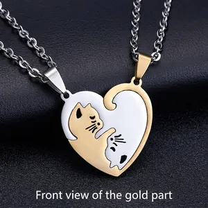 Detailed macro view of cat couple puzzle pendants in gold and silver finish with chain
