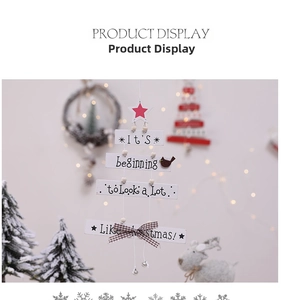 Detail of wooden Christmas sign with star, bird patterns, and plaid bow on festive tree