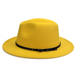 Close-up of bright yellow wool fedora hat with black leather strap and gold buckle detail