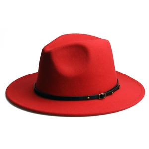 Detail of red wool fedora hat featuring a slim black leather strap and gold buckle