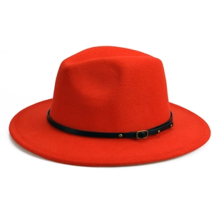 Detail of red wool fedora hat featuring black leather band with gold metal buckles