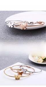 Close-up of 18K gold plated butterfly cuff bracelets in silver, gold, and rose gold
