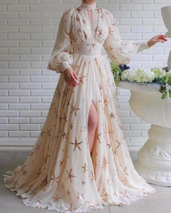 Detail of high neck sequin gown featuring gold starfish embroidery and lantern sleeves
