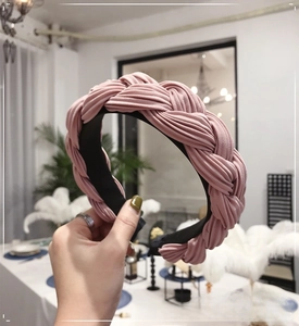 Detail of pink pleated fabric braided headband showing textured woven design and wide fit