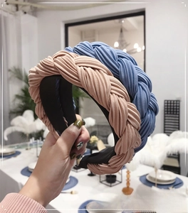 Close-up of pleated chiffon braided headband in pastel pink and light blue colors