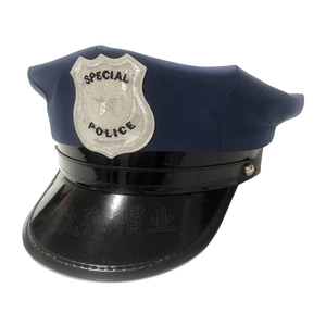 Detail of Special Police hat with silver embroidered shield badge and black patent leather brim