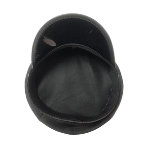 Top view of black leather police cap showing interior lining and flat top structure