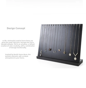 Macro detail of black wood grain jewelry organizer with fourteen necklace display notches