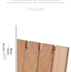 Close-up of minimalist solid wood necklace display stand showing natural beech grain