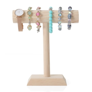 Solid wood T-bar jewelry stand displaying rose gold watch and beaded bracelets on white base